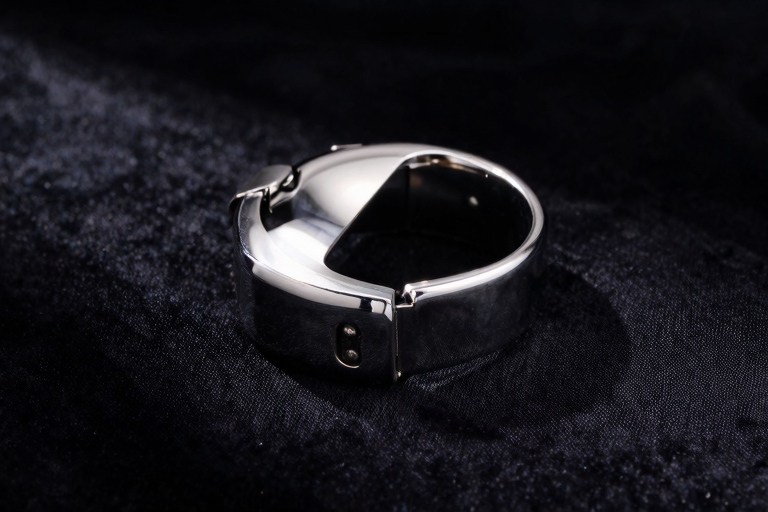 dark metal cock ring placed on black velvet cloth, reflective stainless steel surface, moody studio lighting, minimalist product photography, no text, masterpiece, very aesthetic, score_9, score_8_up